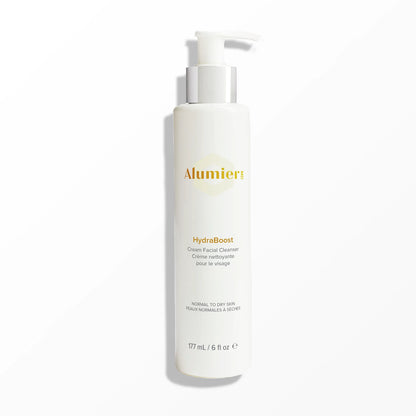 A white pump bottle labeled "Alumier MD HydraBoost Cream Facial Cleanser" stands against a plain background. Text includes "Normal to Dry Skin" and "177 mL / 6 fl oz."