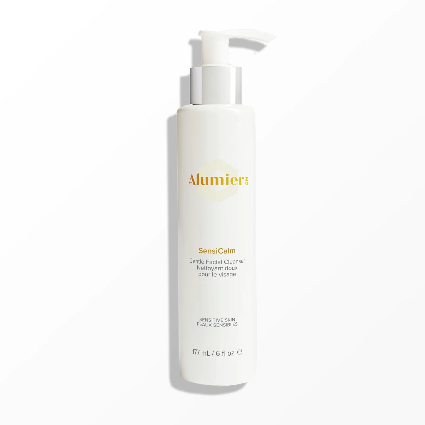 A white pump bottle labeled "Alumier SensiCalm Gentle Facial Cleanser" for sensitive skin stands on a plain light gray background. Additional text: "177 mL / 6 fl oz."