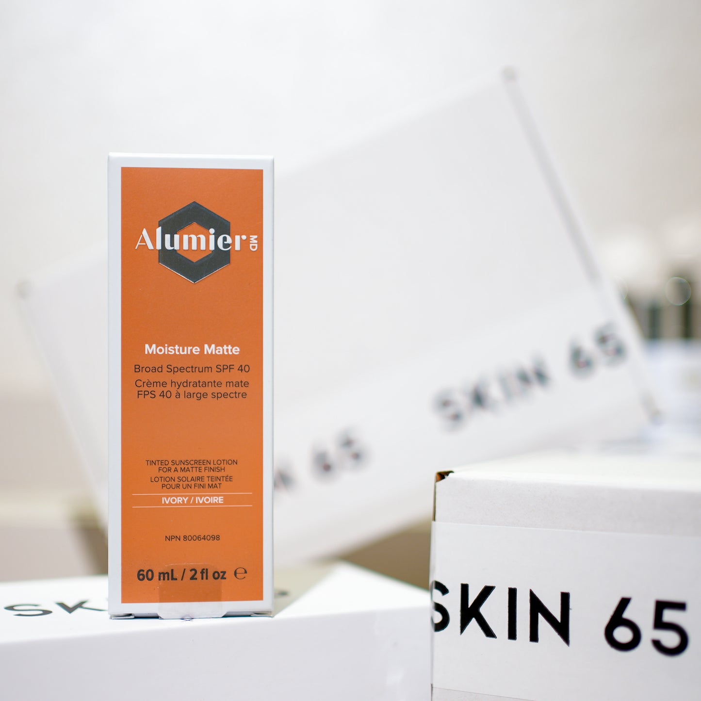 AlumierMD-Moisture-Matte-Broad-Spectrum-SPF40-Ivory-60ml in Box with Skin 65 Branding in the Background