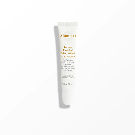 A white tube labeled "Alumier Retinol Eye Gel, Eye Gel with 0.1% Encapsulated Retinol, all skin types, 15ml / 0.5 fl oz" stands upright on a white surface against a light grey background.