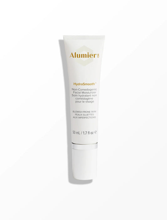 A white tube labeled "AlumierMD HydraSmooth Non-Comedogenic Facial Moisturiser," suitable for blemish-prone skin. Text reads: "50 mL / 1.7 fl oz." The tube is standing upright against a plain background.