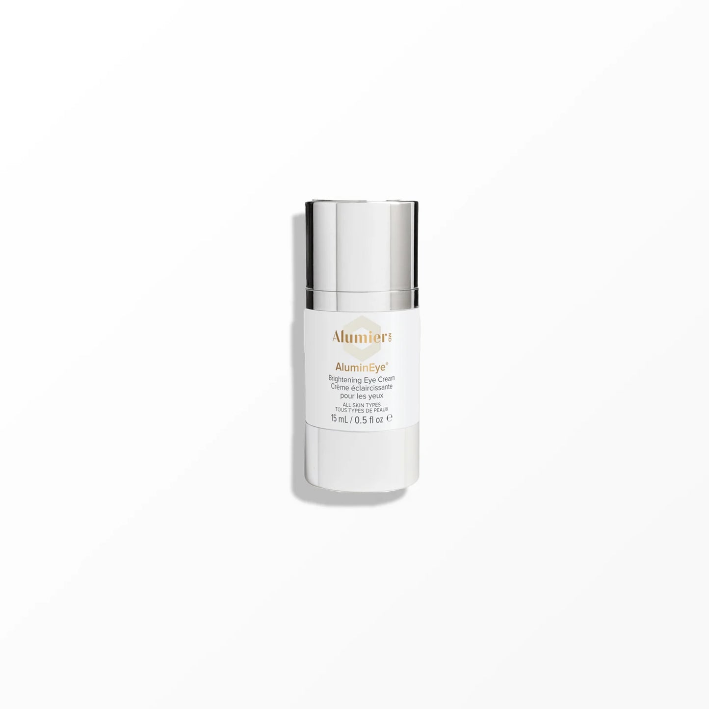 A white bottle with a shiny silver cap labeled "AluminEye® Brightening Eye Cream, Crème éclaircissante pour les yeux, 15 mL / 0.5 fl oz e" stands against a plain light gray background.