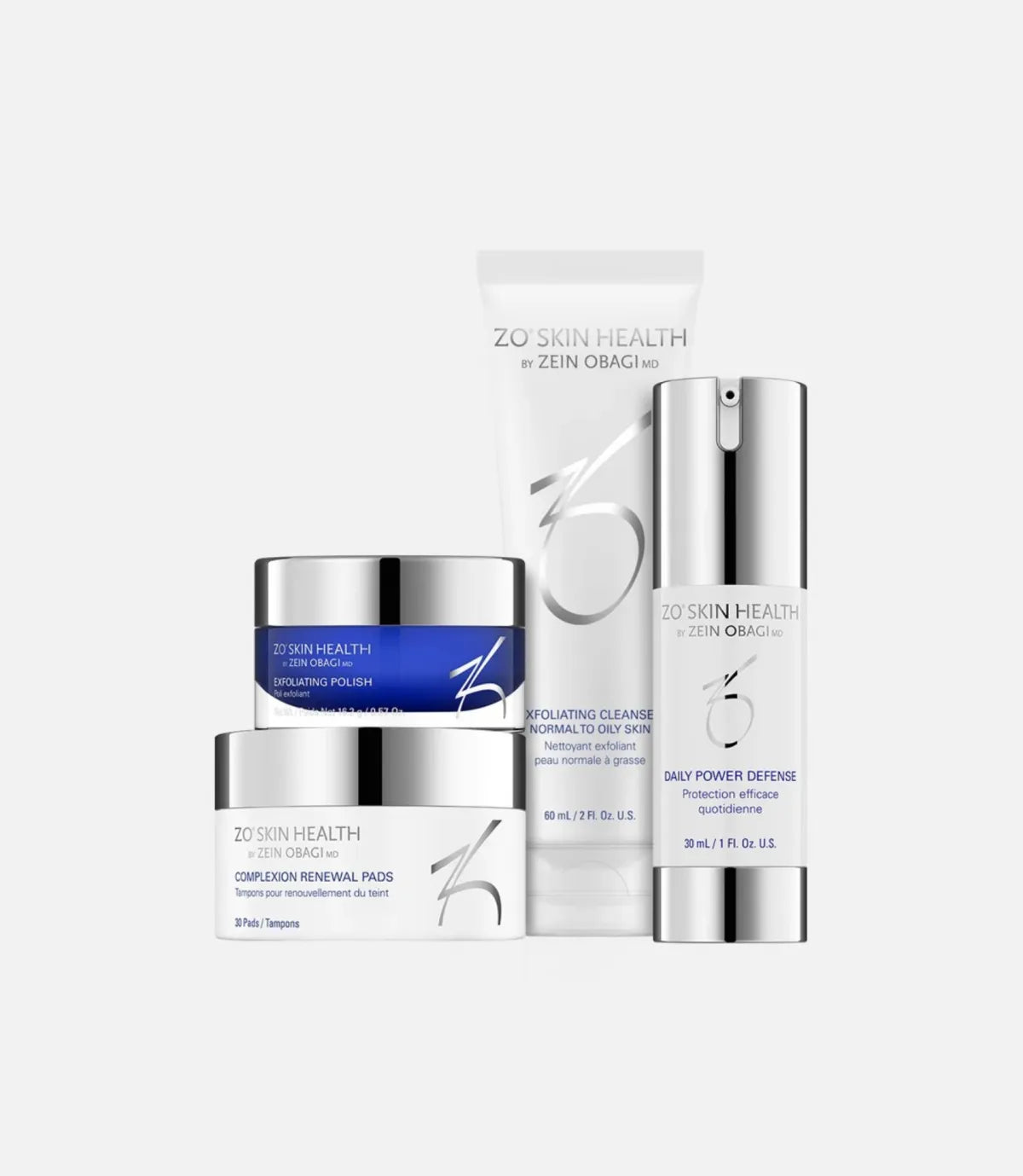 Four skincare products from ZO Skin Health by Zein Obagi MD arranged together. Exfoliating Cleanser (tube), Daily Power Defense (pump bottle), Exfoliating Polish (jar), and Complexion Renewal Pads (jar).