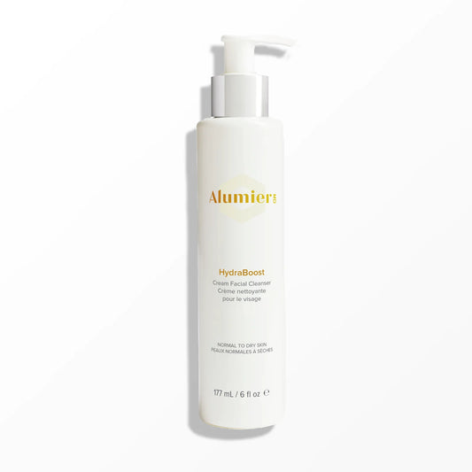 A white pump bottle labeled "Alumier MD HydraBoost Cream Facial Cleanser" stands against a plain background. Text includes "Normal to Dry Skin" and "177 mL / 6 fl oz."