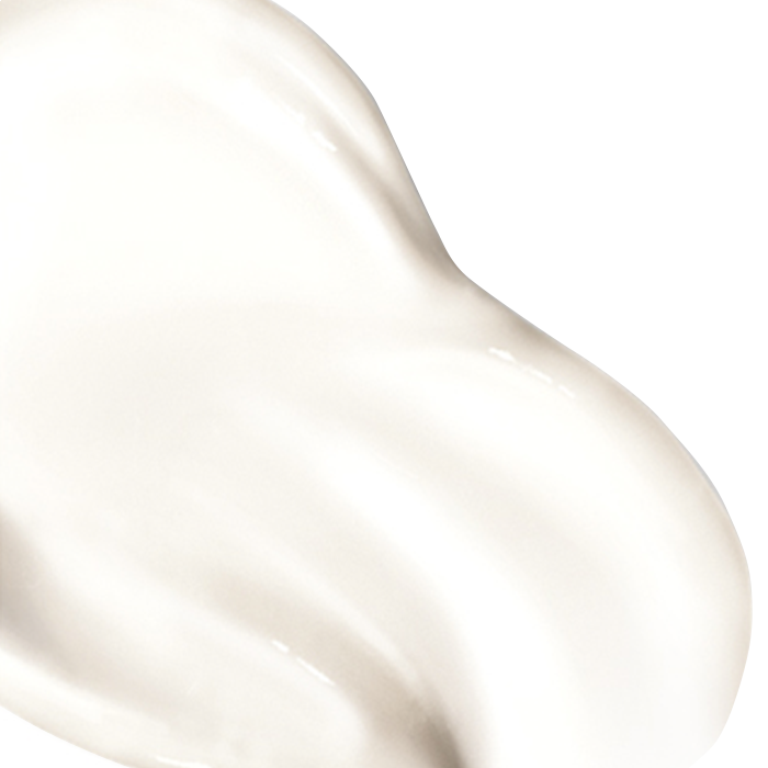 A smooth, creamy white substance with a glistening texture, appears smeared on a plain white background.