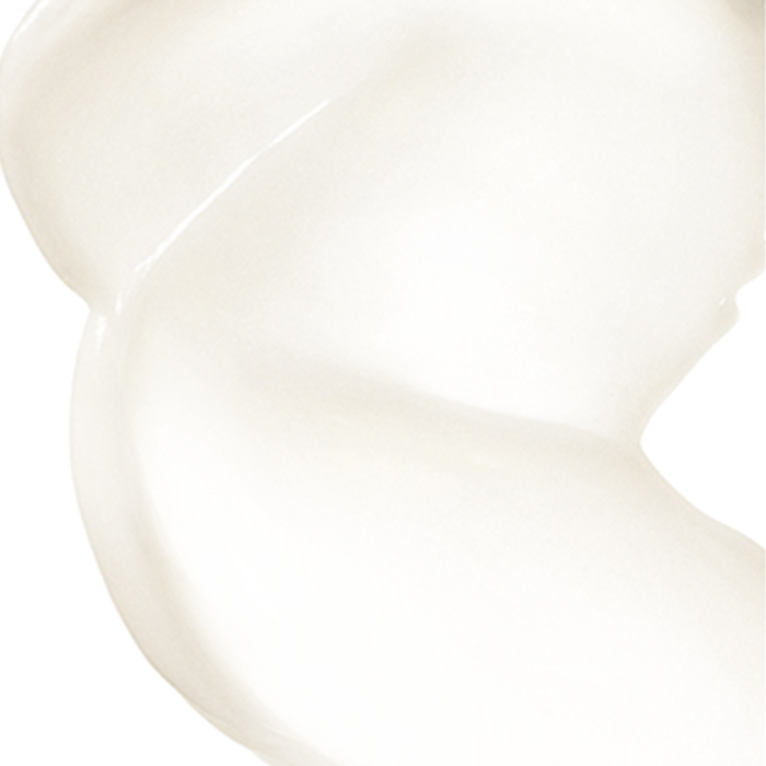 A smooth, creamy swirl of white substance is placed against a plain, white background. The texture appears glossy and thick, consistent with lotion or cream.