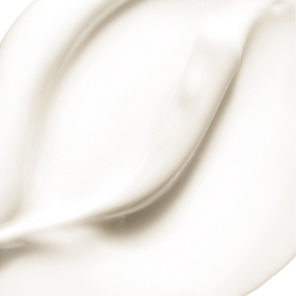 Creamy white substance is spread smoothly, displaying gentle curves and peaks with a glossy texture, resembling lotion or whipped cream.