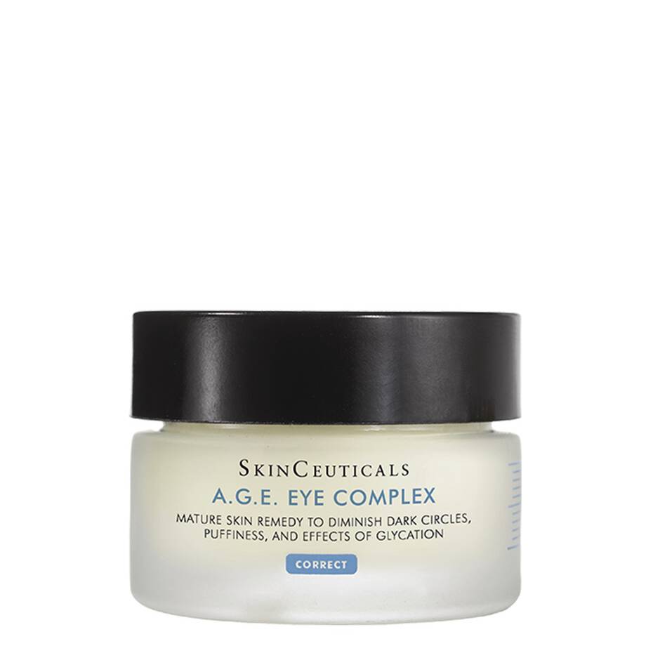 A round jar with a black lid contains SkinCeuticals A.G.E. Eye Complex cream. The label reads: "Mature skin remedy to diminish dark circles, puffiness, and effects of glycation. CORRECT." The jar is placed against a plain, white background.