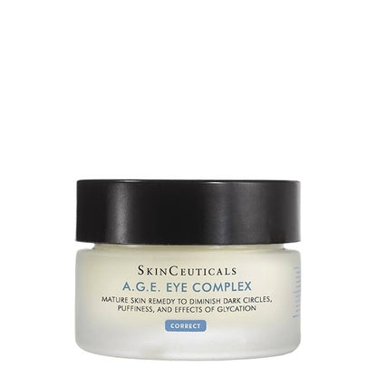 A round jar with a black lid contains SkinCeuticals A.G.E. Eye Complex cream. The label reads: "Mature skin remedy to diminish dark circles, puffiness, and effects of glycation. CORRECT." The jar is placed against a plain, white background.