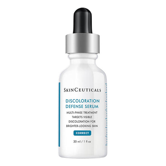 A white dropper bottle labeled "SkinCeuticals Discoloration Defense Serum" stands upright. Text reads: "Multi-phase treatment targets visible discoloration for brighter-looking skin. CORRECT. 30 ml / 1 fl oz."