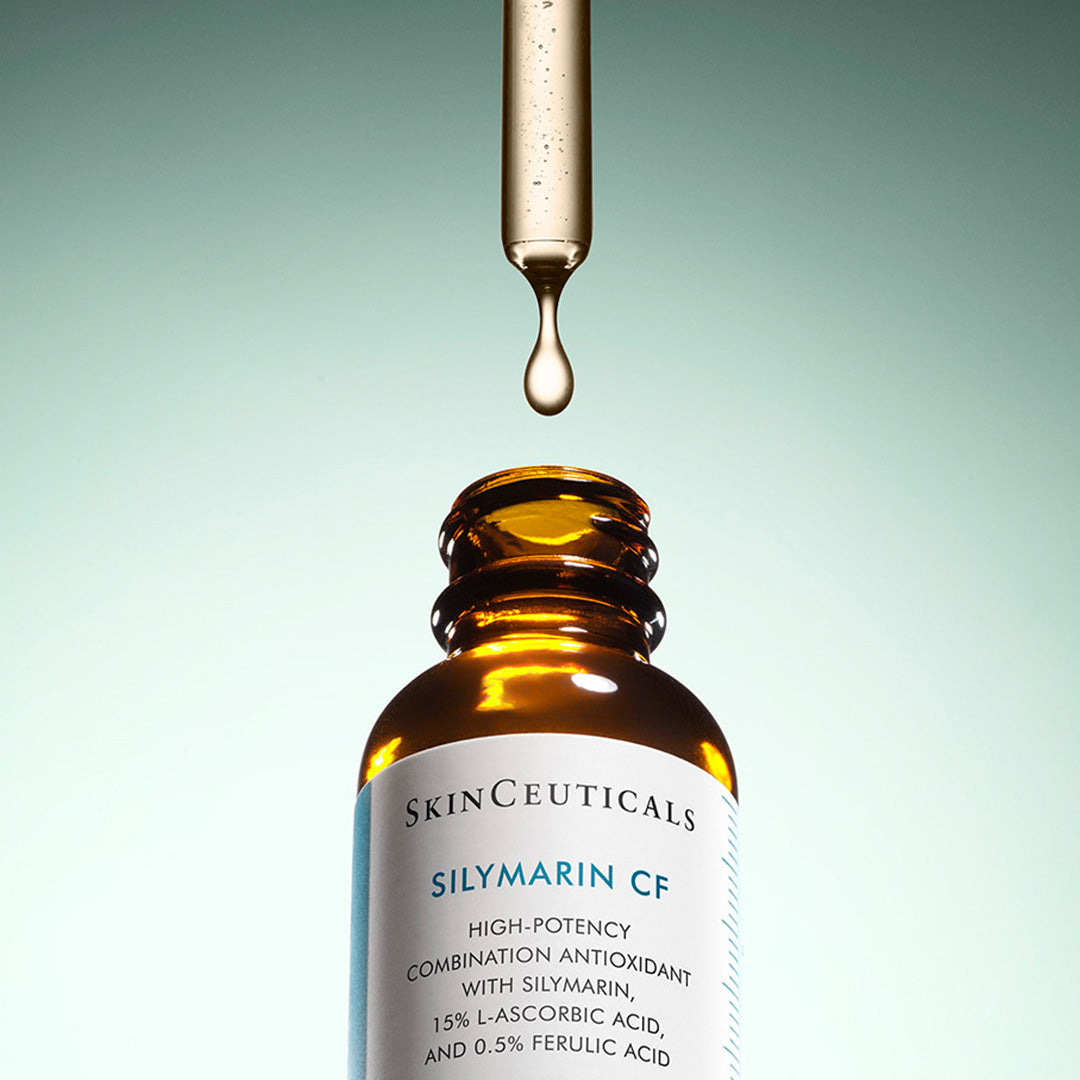 A dropper releases a liquid drop into an amber bottle labeled "SkinCeuticals SILYMARIN CF High-Potency Combination Antioxidant with Silymarin, 15% L-Ascorbic Acid, and 0.5% Ferulic Acid," against a gradient background.