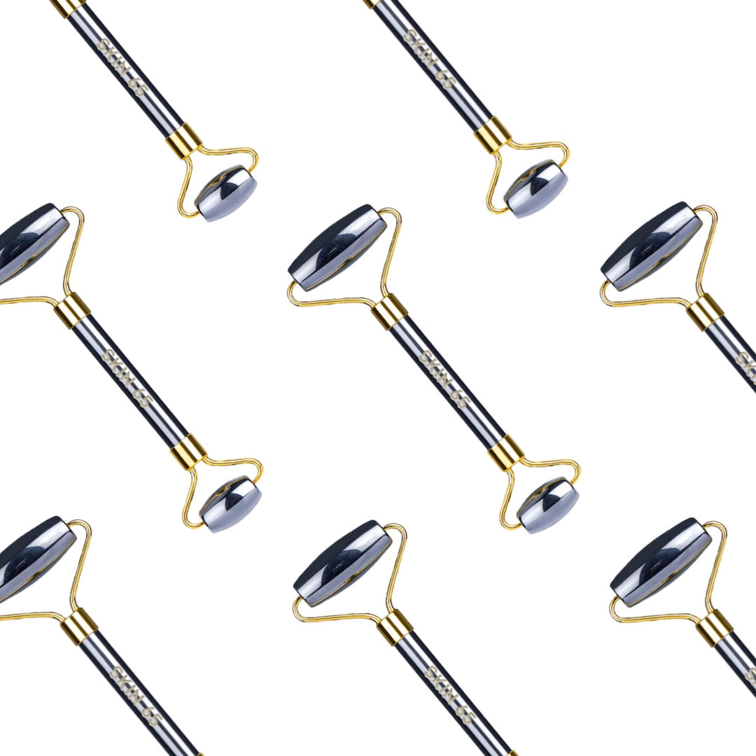 Facial rollers with black handles and gold accents are arranged in a diagonal pattern on a white background. The handles feature the text "Skatts."