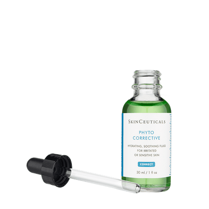 A glass bottle of SkinCeuticals Phyto Corrective serum with a dropper placed beside it. The label reads "Hydrating, soothing fluid for irritated or sensitive skin, 30 ml / 1 fl oz."